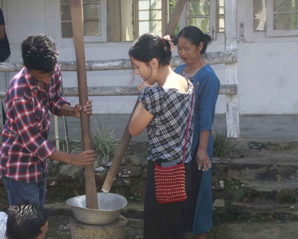 Participants engage in traditional grain pounding using a wooden mortar and pestle during a skill development programme on self-sustenance at the Kobulong EAC Subdivision on October 19.